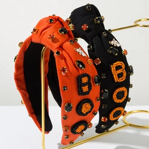 Detail of Halloween knot headbands with BOO patches and rhinestones on display