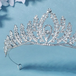 Detailed view of silver bridal crown featuring sparkling rhinestones and leaf motifs