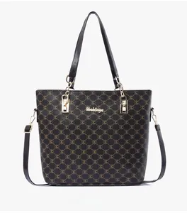 Front view of large capacity tote bag featuring brown M-monogram pattern and gold hardware