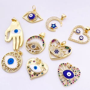 Detailed close-up of golden evil eye pendants with colorful enamel and zircon stones