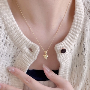 Elegant 925 sterling silver irregular heart necklace in gold finish on female model