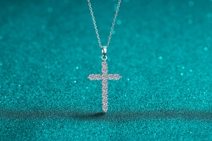 Detailed close-up of S925 sterling silver cross necklace with pavé moissanite stones