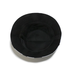 Detail view of fisherman hat showing black and white checkered pattern and black lining