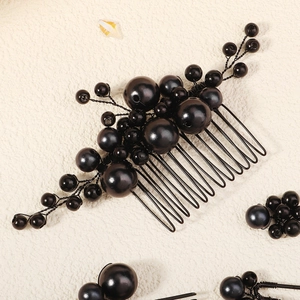 Detail view of handmade black beaded bridal hair comb and hair pins with metallic wires