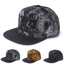 Detail view of hip hop snapback cap with embroidered K and three color variant options