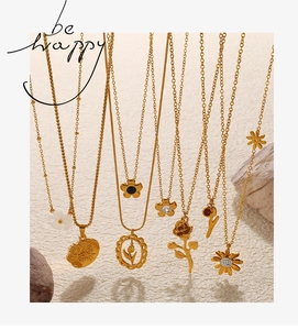Artistic display of assorted gold daisy and tulip pendant necklaces with zircon accents