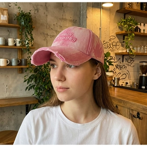 Detail of pink vintage washed baseball cap with letter embroidery and flame print