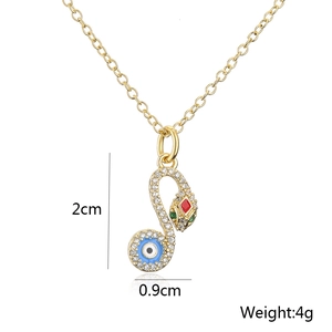 Detailed view of gold plated snake pendant with red eyes and blue evil eye tail design