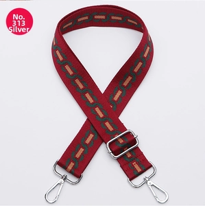 Adjustable red woven bag strap with green chain pattern and silver metal hooks