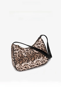 Detail of leopard print hobo bag showing faux leather strap and golden zipper closure