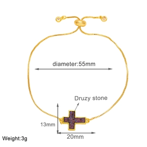 Detail view of gold adjustable box chain bracelet with purple druzy stone cross charm