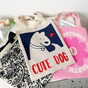 Three cute floral knit tote bags with text prints displayed on a bright desk