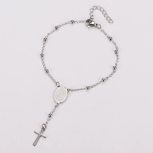 Detail of silver rosary bracelet with Virgin Mary medal and polished cross charm
