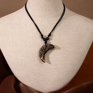 Detail of Maori style necklace with eagle claw pendant and wood bead on a linen model