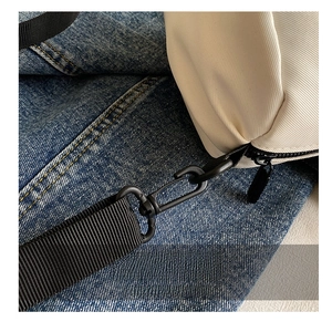 Macro view of high-density black nylon shoulder strap and premium metal hook details