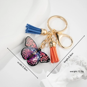Detail view of colorful acrylic butterfly keychain with size and weight measurements