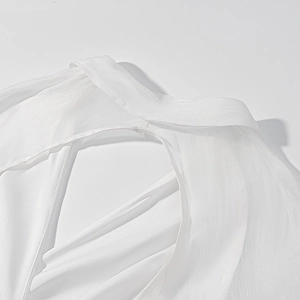 Detailed macro view of white shirt neckline and shoulder tailoring with textured fabric