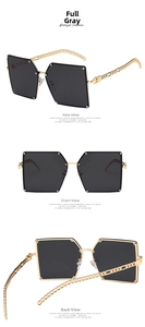 Oversized square sunglasses featuring grey lenses and gold metal chain temples