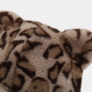 Macro view of leopard print plush faux fur texture on a thick winter headwear piece