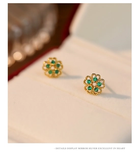 Detailed close-up of S925 silver flower stud earrings with green gemstone and gold finish