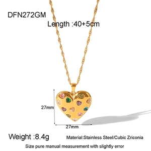 Detailed view of a gold heart pendant necklace with colorful cubic zirconia stones