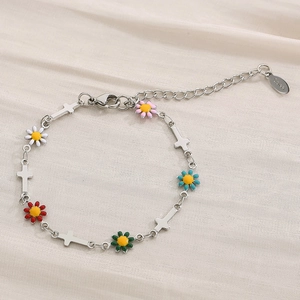 Detail of silver stainless steel daisy bracelet with colorful charms and lobster clasp