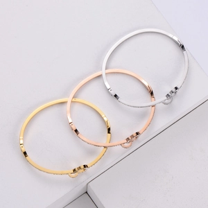 Detailed comparison of gold, rose gold, and silver heart-shaped bangles with small diamonds