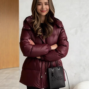 Women's burgundy hooded puffer coat with adjustable drawstring waist and quilted finish