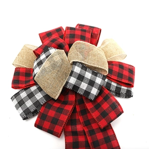 Large red and black plaid Christmas bow with rustic burlap ribbons for holiday decoration