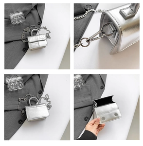 Detail view of mini silver metallic bag with croc pattern, chain strap, and top handle
