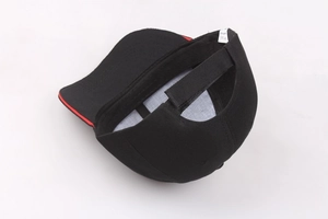 Detail of adjustable velcro strap and red edge trim on black cotton baseball cap