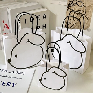 Three-piece set of white paper gift bags with minimalist dog illustrations in various sizes