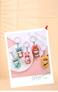 Detail of 5-pack shiba inu dog keychains in various colorful animal cartoon costumes