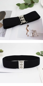 Detail of a 5cm black elastic dress belt with a polished silver triple-hole metal buckle