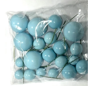 Mix of various sized blue decorative foam cake balls with green stems in a clear bag