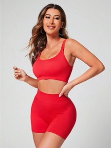Dettaglio di reggiseno sportivo a coste rosso e pantaloncini da ciclista a vita alta