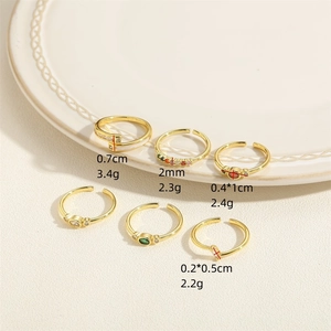 Gold open rings set with colorful zircon and green stones in minimalist designs