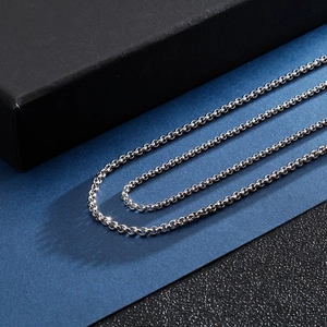 Detailed macro view of high-polished silver stainless steel rolo chain necklace