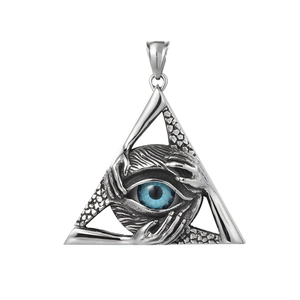 Macro shot of vintage triangle eye pendant with blue eye and aged metal texture