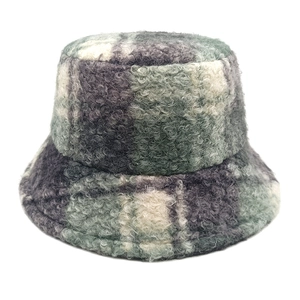 Detailed texture of thick lamb wool plaid bucket hat in grey and green check