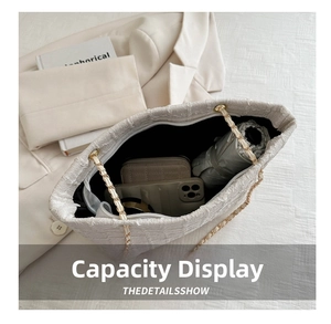 Detail view of large capacity beige tote bag showing spacious interior for daily items