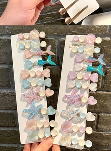 Detail showing colorful macaron hair clips with seashell, mermaid and starfish designs