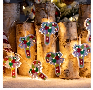 Detail of candy cane LED string lights with snowflake patterns on birch wood