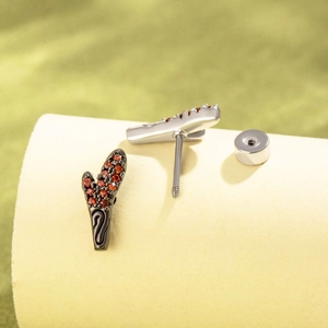 Unique dragon horn stud earrings in black steel with red cubic zirconia stones