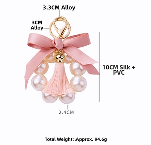 Macro shot of pink silk bow pearl tassel keychain with gold alloy hardware and dimensions