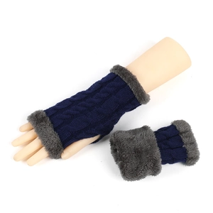 Detail view of navy cable knit fingerless gloves with soft grey faux fur trim detailing