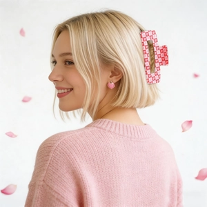 Pink checkered heart hair claw clip and matching heart earrings worn on blonde hair