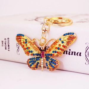 Colorful crystal butterfly keychain in gold finish with blue and orange rhinestones
