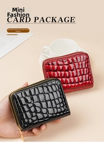 Detail of crocodile embossed leather card holders with gold zippers in black and red