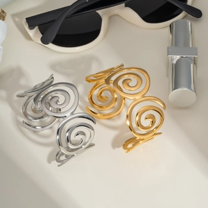 Modern minimalist gold and silver spiral open bangles with sunglasses and lipstick accessories